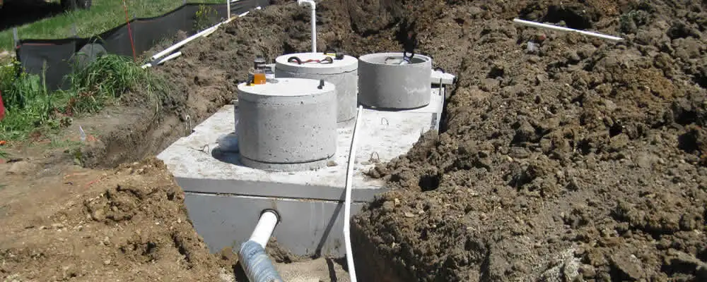 Septic system repair and installation site with tank access ports in Olathe, KS