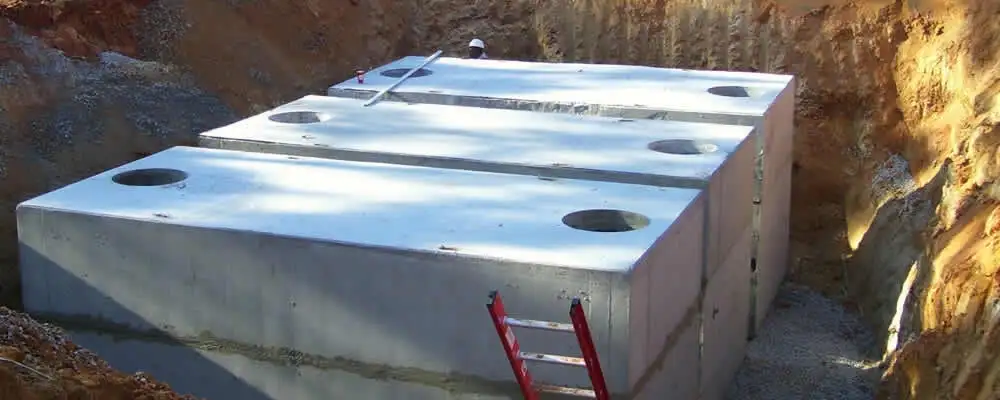 Septic tank installation site with a newly placed concrete tank in Olathe, KS